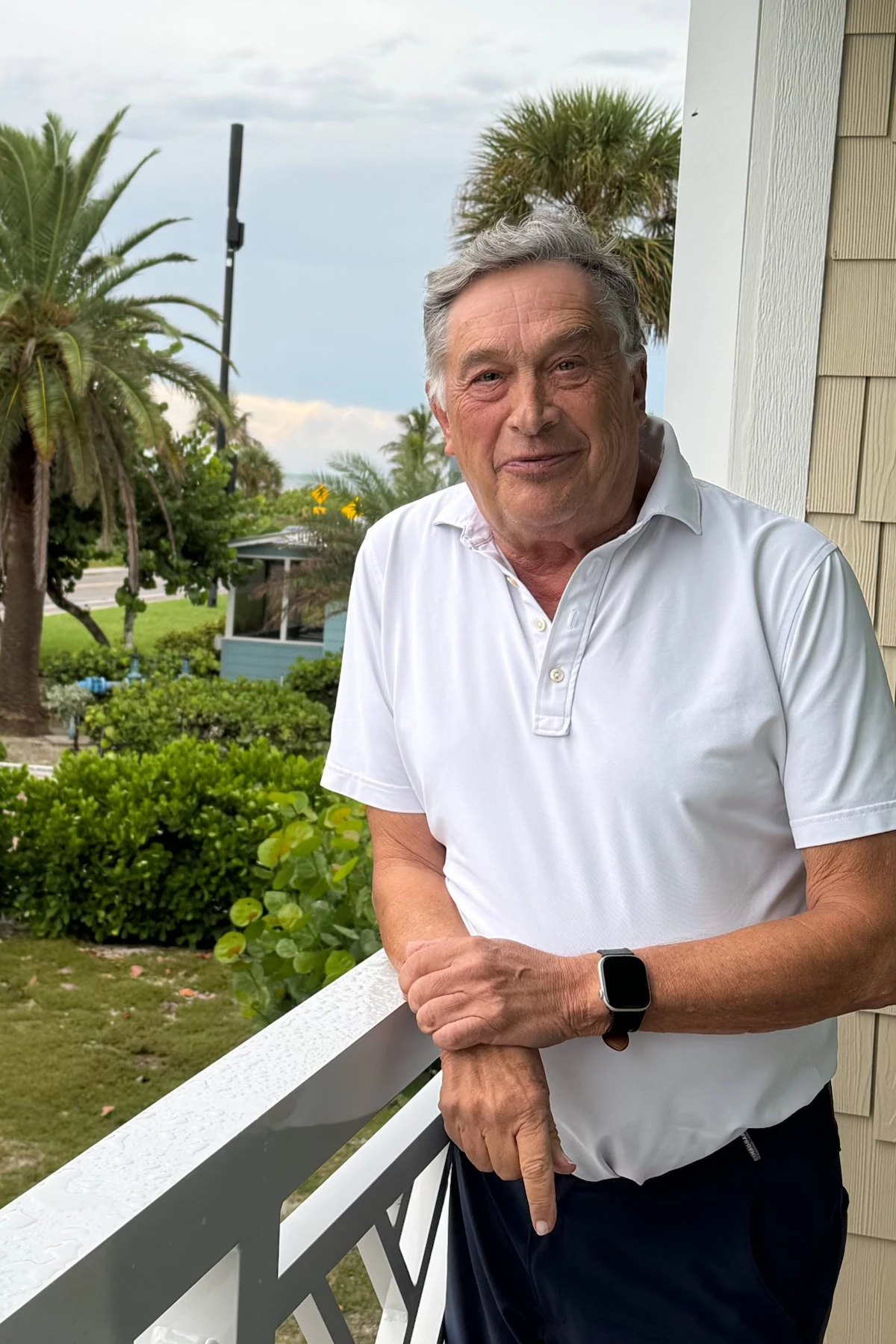 Peter Benario standing on a balcony in Florida.